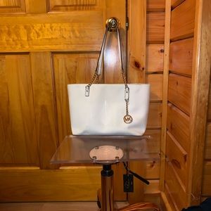 white with gold logo michael kors purse